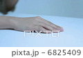 The hands of a young lady painting nail polish 6825409