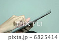 A woman's hand, finger of the operation watching a photo on a tablet PC 6825414