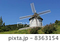 A windmill rotating on a hill 8363154