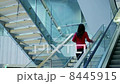 Business Woman Moving Upstairs in Office Building. 8445915