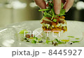 Chef Serving Delicious Seafood Salad in Luxury Restaurant 8445927