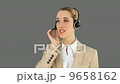 Smiling call centre agent talking on the headset 9658162