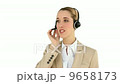 Smiling call centre agent talking on the headset 9658173