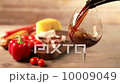 Pouring red wine and snacks 10009049