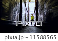 A male industrial worker walks in between rows of goods in a warehouse 11588565