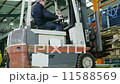 Time lapse of busy warehouse workers lifting and moving goods and materials 11588569