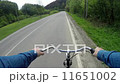 rides a bicycle on a country road 11651002
