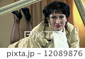 Close shot of baroque mistress in prone position holding a frame 12089876