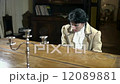 Lady plays a piano in romantic clothes 12089881