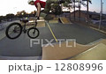Extreme Sport BMX Bicycle Rider Doing Tricks in Concrete Skate Board Park 12808996