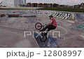 Extreme Sport BMX Bicycle Rider Doing Tricks in Concrete Skate Board Park 12808997