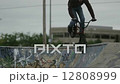 Extreme Sport BMX Bicycle Rider Doing Tricks in Concrete Skate Board Park 12808999