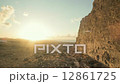 Early morning sun rising on the Canary Island of Lanzarote as the camera ascends by old city ruins 12861725