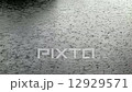 Close Up shot of heavy rain hitting the water surface 12929571