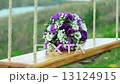 Wedding bouquet and golden rings on seesaw 13124915