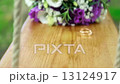 Wedding bouquet and golden rings on seesaw 13124917
