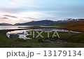 Tranquil lakes fringed by volcanic mountains 13179134