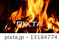 Stoking a blazing fire in a domestic fireplace 13184774