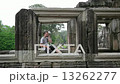 caucasian tourist talking with mobile phone in angkor  13262277