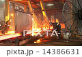 Workers cutting fiery steel blocks 14386631