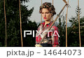 Elegant Fashion Model Poses For Photo Shoot With Pickaxe In Garden 14644073