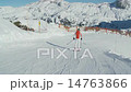 steadycam following female skier on a red piste 14763866