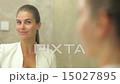 Pretty woman applying make up 15027895