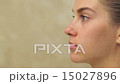Pretty woman applying make up, close up 15027896