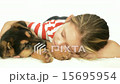beautiful girl sleeps embracing Shepherd puppy 15695954