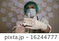 Doctor with a syringe in a mask preparing to injec 16244777