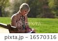 attractive woman writing on the park bench 16570316