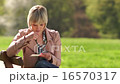 sad woman looking and reading letter outside 16570317