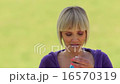 attractive sporty woman drinking isotonic outside 16570319