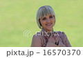 Attractive woman smiling outside 16570370