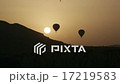 Balloons fly against the sun during sunrise 17219583
