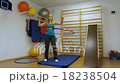 Woman using a hula hoop in her training in the gym 18238504