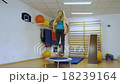 Young woman jumping on the trampoline in the gym 18239164