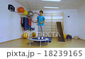 The young man jumping on a trampoline in the gym 18239165