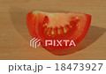 A tomato slice on a table 18473927