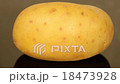 A ripe potato on a black pan closeup 18473928
