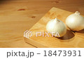 Three onions on a wooden board 18473931