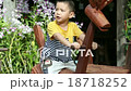 asian kid playing on the wooden rocking Horse 18718252