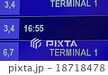 Airport departure board in terminal with "DELAYED" 18718478