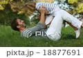 Father and son lying and playing in the meadow 18877691