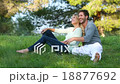 Beautiful couple sitting in the green meadow 18877692
