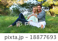 Beautiful blond couple sitting in the green meadow 18877693