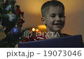 A chinese boy was very happy to take the gifts 19073046