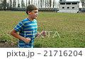 Child teen boy is running, jogging in jeans, sport 21716204