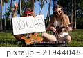 Joyful Hippie Girls Playing Guitar Outdoor with 21944048