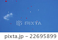 Red and white balloons in blue sky 22695899